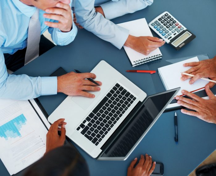 Cropped image of group of businesspeople working together in office - Consulting